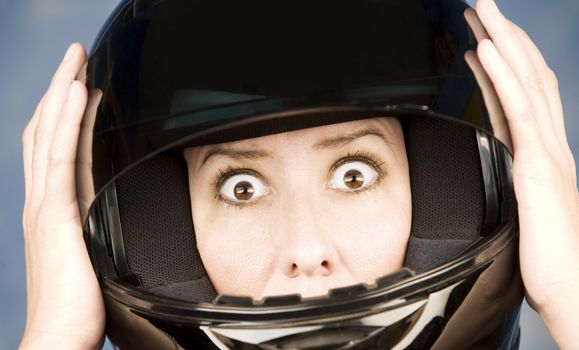 Woman with a black motrcycle helmet and surprised expression