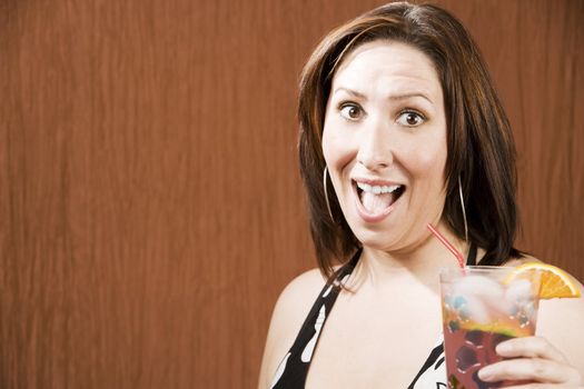 Hispanic woman having fun and holding a drink