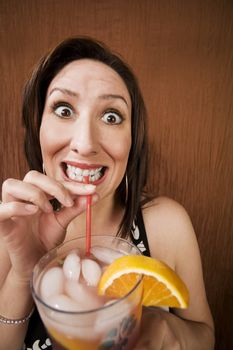 Hispanic woman having fun and holding a drink