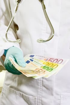 Doctor in detail with euro banknotes