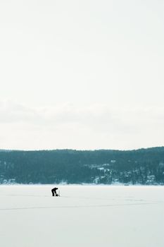 A person Ice fishing on the oslo fjord in early March.