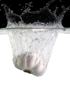 garlic thrown in water with black and white background