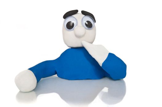 Close and low level of an isolated over white plasticine character with a forgetful expression.