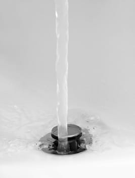 running water in bottom of a sink, black and white