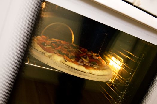 A homemade pizza baking in an oven