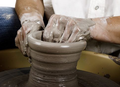 Close-up picture of a potter works a potter's wheel