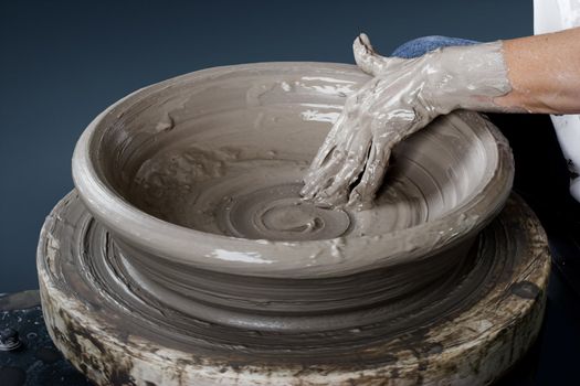 Close-up picture of a potter works a potter's wheel