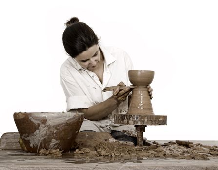 Picture of a potter works on a wood potter's wheel