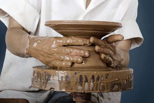 Close-up picture of a potter works a potter's wheel