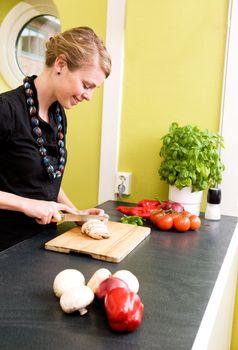 A woman cutting vegetables at home on the counter