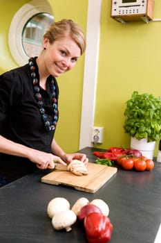 A woman cutting vegetables at home on the counter