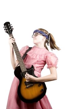 Young girl in a pink dress with an electric rock guitar