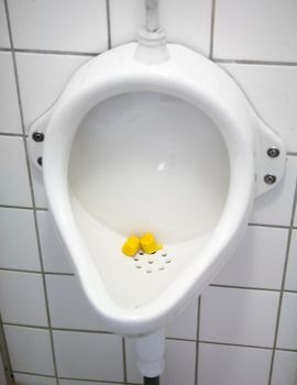 A close up of a public urinal