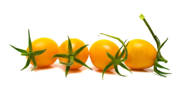 perfect yellow tomatoes on the white. Full isolation, shallow DOF.