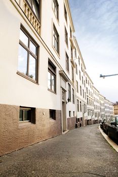 A row of similiar buildings on a tight street in Oslo Norway