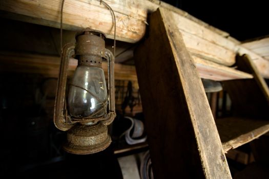 An old lantern hanging in a barn