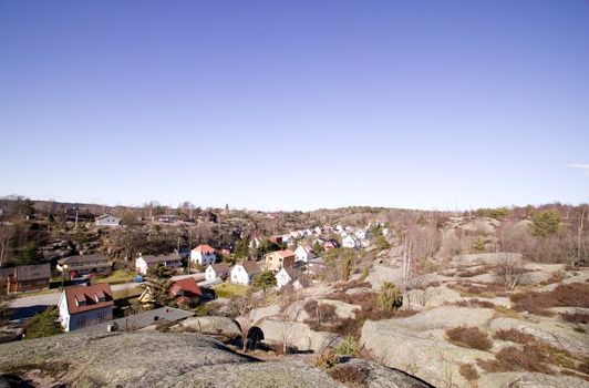 A street following a valley in a rock countryside.  Fredrikstad Norway.