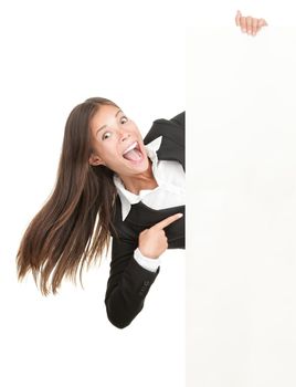 Excited woman pointing at sign. Businesswoman screaming of joy is holding blank billboard placard and pointing at empty copy-space. Isolated on white background.