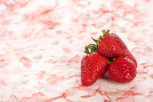 Delicious strawberries on a pink background