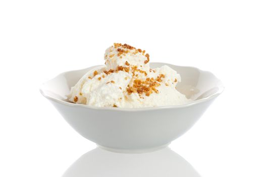 Bowl with vanilla icecream and crumbled nuts on top