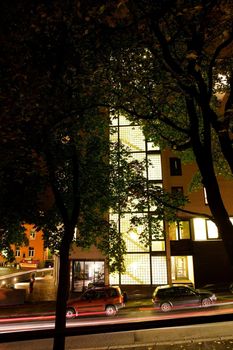 A street at night with a staircase in a modern building.