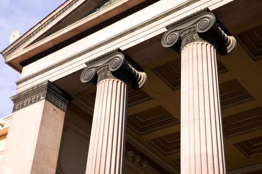 A detail of an old building built in the old Greek style with Ionic columns.