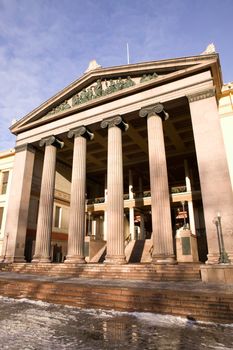 A detail of an old building built in the old Greek style with Ionic columns.