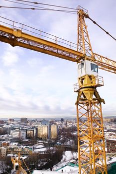 A detail of a crane overlooking the Oslo fjord and city of Oslo.