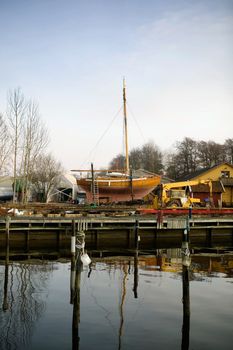 A boat harbor in the late fall painted in the evening light of sunset