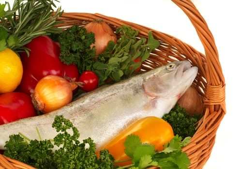 Still life. Basket with fresh vegetables and trout. 