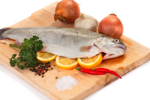 Fresh trout on a wooden board with spices