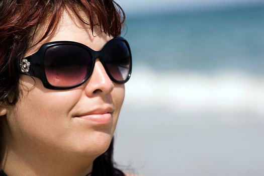 Close-up portrait of a beautiful plus size model at the beach.