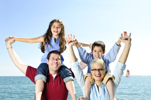 Happy family having fun giving shoulder rides