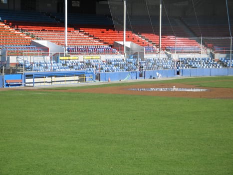 green baseball field with seats