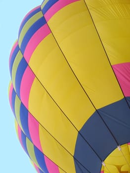 Segment of a hot air balloon shown against blue sky