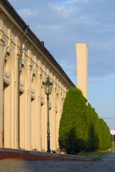 Architectural detail of several arches and trees in a row