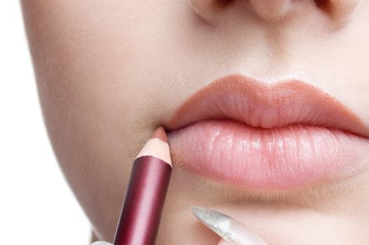 make up, applying lips liner pencil on beautiful lips
