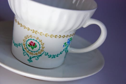 porcelain cup, kitchen utensils, drawing on the cup, pattern, beautiful, white mug, cup saucer, a favorite cup