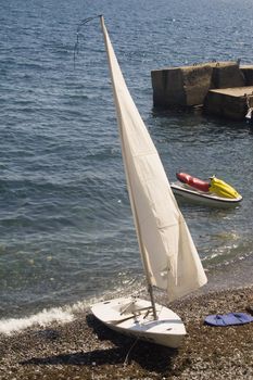 small sailboat on shore
