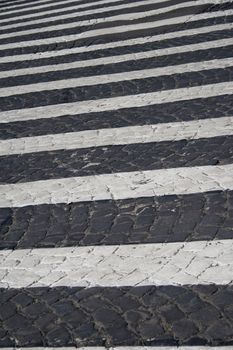 Detail of zebra striped pedestrian walk on cobblestone street