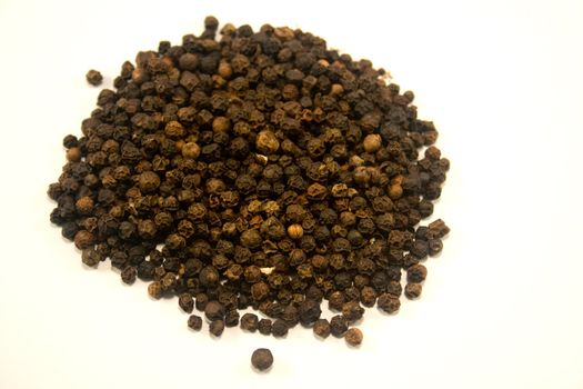 whole peppercorns against white