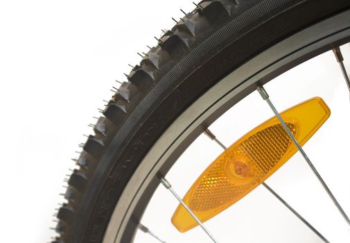 Close-up of a mountain bike tyre with reflector