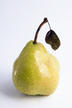 Ripe juicy pear covered by drops of water. Isolation on white, shallow DO.