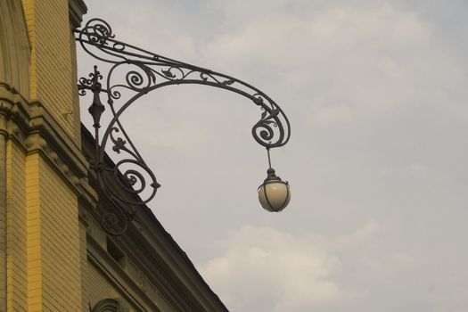 Ornate lamp on side of building