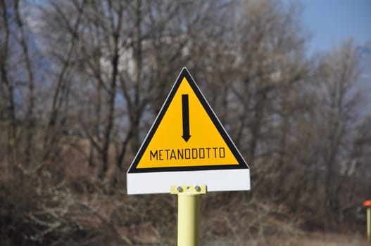 A methane pipeline warning sign in Italian 'metanodotto'