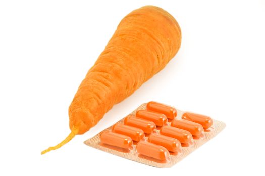 Vitamin pills with carrot on isolated white. Make your choice