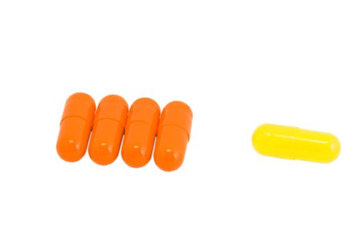 Few vitamin pills on isolated white. Make your choice