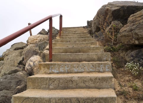 Worn concrete stairs, complete with graffiti.