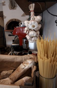 spaghetti, bread and garlic  in front of a pizza oven