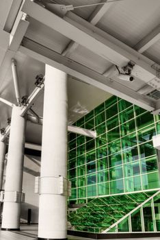 Green windows in station with pillar in modern city.